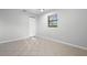 Neutral bedroom features tile floors, window, and closet at 265 S Fairbairn Dr, Deltona, FL 32725