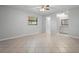 Spacious bedroom with tile flooring, ceiling fan, and doorway to bathroom with vanity at 265 S Fairbairn Dr, Deltona, FL 32725