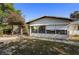 Charming home exterior with a wooden pergola and lush landscaping at 265 S Fairbairn Dr, Deltona, FL 32725