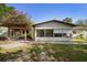 Charming front yard with a pergola and lush landscaping at 265 S Fairbairn Dr, Deltona, FL 32725