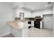 Clean kitchen featuring white cabinets, tile backsplash, and modern appliances, illuminated by natural light at 265 S Fairbairn Dr, Deltona, FL 32725