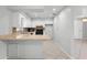 Bright kitchen features white cabinetry, neutral countertops, and sleek black appliances for a modern touch at 265 S Fairbairn Dr, Deltona, FL 32725