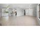 A bright and open living space with tiled floors, ample natural light, and access to kitchen and sun room at 265 S Fairbairn Dr, Deltona, FL 32725