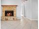 Cozy living room featuring a stone fireplace and neutral tile flooring at 265 S Fairbairn Dr, Deltona, FL 32725