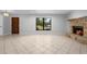 Open living room with a stone fireplace, natural light, and neutral tile flooring at 265 S Fairbairn Dr, Deltona, FL 32725