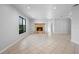 An expansive living room with a cozy fireplace, large window, and an open layout for versatile furniture arrangement at 265 S Fairbairn Dr, Deltona, FL 32725