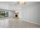 Bright, open living room featuring a stone fireplace and neutral tile flooring at 265 S Fairbairn Dr, Deltona, FL 32725