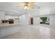 Open-concept living area with combined kitchen and dining, complemented by tile floors and natural light at 265 S Fairbairn Dr, Deltona, FL 32725