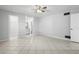 Spacious main bedroom with tile flooring, ceiling fan, and bathroom doorway at 265 S Fairbairn Dr, Deltona, FL 32725