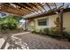 Back patio featuring a wooden pergola and a whimsical water fountain mural at 265 S Fairbairn Dr, Deltona, FL 32725