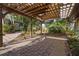 Back patio featuring a wooden pergola and red brick paving stones at 265 S Fairbairn Dr, Deltona, FL 32725