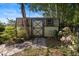 Outdoor shed nestled in a lush garden with flowers and a quaint brick pathway at 265 S Fairbairn Dr, Deltona, FL 32725