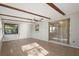 Sunroom with multiple windows for natural light, ceiling fan, and sliding door to an enclosed space at 265 S Fairbairn Dr, Deltona, FL 32725