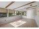 Bright sunroom featuring exposed beams and lots of windows at 265 S Fairbairn Dr, Deltona, FL 32725