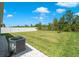 Spacious backyard with lush green lawn, AC unit and a white vinyl fence at 2686 Neverland Dr, New Smyrna Beach, FL 32168