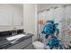 Bathroom featuring a dark marble countertop and shower with a decorative curtain featuring sea turtles at 2686 Neverland Dr, New Smyrna Beach, FL 32168