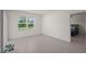 Bright bedroom with light floors and neutral walls featuring a window with blinds allowing for natural light at 2686 Neverland Dr, New Smyrna Beach, FL 32168
