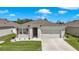Inviting single-story home featuring a two-car garage, landscaped front yard, and a cozy, neutral color scheme at 2686 Neverland Dr, New Smyrna Beach, FL 32168