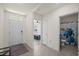 Bright foyer with tile flooring, leading to a bedroom and bathroom, enhancing the home's spacious feel at 2686 Neverland Dr, New Smyrna Beach, FL 32168