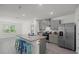 Modern kitchen featuring gray cabinets, granite countertops, stainless steel appliances, and a center island with seating at 2686 Neverland Dr, New Smyrna Beach, FL 32168