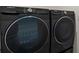 Modern laundry room features high-efficiency black Samsung washer and dryer set at 2686 Neverland Dr, New Smyrna Beach, FL 32168