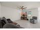 Spacious living room with modern floors, large windows, and a ceiling fan for comfortable living at 2686 Neverland Dr, New Smyrna Beach, FL 32168