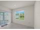 Bright living room featuring sliding glass doors with access to the backyard and neutral colored walls and light floors at 2686 Neverland Dr, New Smyrna Beach, FL 32168