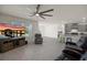 Open-concept living room featuring modern flooring, a ceiling fan, and an adjacent kitchen area at 2686 Neverland Dr, New Smyrna Beach, FL 32168