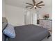 Bedroom featuring light floors, neutral walls, a ceiling fan, and a coordinating bed set with gray tones at 2686 Neverland Dr, New Smyrna Beach, FL 32168