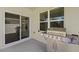 Outdoor patio area with stainless steel barbecue grill, sliding glass door, and a window at 2686 Neverland Dr, New Smyrna Beach, FL 32168