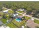 An aerial view of a home with a private pool, fenced yard, and lush landscaping in a quiet neighborhood at 2819 Silver Palm Dr, Edgewater, FL 32141