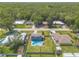 Aerial shot showcases a charming home with a private pool, surrounded by a well-manicured lawn and a fenced yard at 2819 Silver Palm Dr, Edgewater, FL 32141