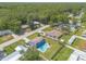 Aerial view of a home featuring a sparkling pool, well-maintained lawn, mature trees, and privacy fencing at 2819 Silver Palm Dr, Edgewater, FL 32141