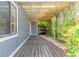 Cozy back porch with a wooden pergola and climbing vines, creating a tranquil outdoor space at 2819 Silver Palm Dr, Edgewater, FL 32141