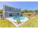 Inviting backyard with a sparkling pool, surrounded by lush landscaping and comfortable seating areas at 2819 Silver Palm Dr, Edgewater, FL 32141