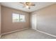 Neutral bedroom with large window, ceiling fan and double door closet at 2819 Silver Palm Dr, Edgewater, FL 32141
