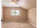 A spacious bedroom features a vaulted ceiling, a window for natural light, and plush carpeting at 2819 Silver Palm Dr, Edgewater, FL 32141