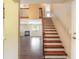 Inviting entryway featuring hardwood stairs and an open view into the spacious living room with fireplace at 2819 Silver Palm Dr, Edgewater, FL 32141