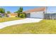 Charming home with a well-manicured lawn and a freshly painted driveway leading to an attached garage at 2819 Silver Palm Dr, Edgewater, FL 32141