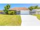 Charming single-story home featuring a well-maintained lawn and a spacious driveway leading to an attached garage at 2819 Silver Palm Dr, Edgewater, FL 32141