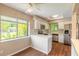 Well-lit kitchen with stainless steel appliances, white cabinets, a breakfast nook, and a large window overlooking the yard at 2819 Silver Palm Dr, Edgewater, FL 32141