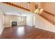 Spacious living room showcasing wood floors, a cozy fireplace, and a staircase to the upper level at 2819 Silver Palm Dr, Edgewater, FL 32141