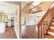 Open-concept living space with hardwood floors, vaulted ceilings, and a staircase leading to the upper level at 2819 Silver Palm Dr, Edgewater, FL 32141