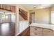 Open-concept living area with modern kitchen, hardwood floors, a staircase, and plenty of natural light at 2819 Silver Palm Dr, Edgewater, FL 32141
