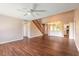 Open-concept living space with hardwood floors, staircase, and kitchen with breakfast bar at 2819 Silver Palm Dr, Edgewater, FL 32141