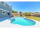 Backyard featuring a sparkling swimming pool with an attached spa and a spacious patio area for entertaining guests at 2819 Silver Palm Dr, Edgewater, FL 32141