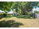 Large backyard with mature trees and a wooden fence, providing privacy and natural beauty at 291 Sagewood Dr, Port Orange, FL 32127