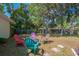 Large, private backyard with colorful chairs provides ample space for outdoor gatherings at 291 Sagewood Dr, Port Orange, FL 32127
