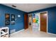 This bedroom features charming blue walls and a doorway, offering a bright and inviting space at 291 Sagewood Dr, Port Orange, FL 32127