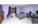 Cozy bedroom with purple walls, a large window, and neutral patterned flooring at 291 Sagewood Dr, Port Orange, FL 32127